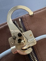 LOUIS VUITTON PARIS, MADE IN FRANCE” brown nylon garment sleeve & « LV » hanger