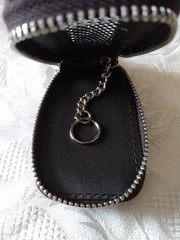 Leather zip up pouch with keyring.