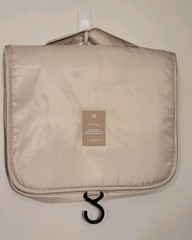 Beige Travel hanging toiletry bag designed to organize personal care items.